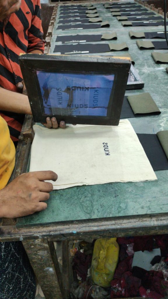 screen printing Kind2 logo on a handwoven khadi cotton bag